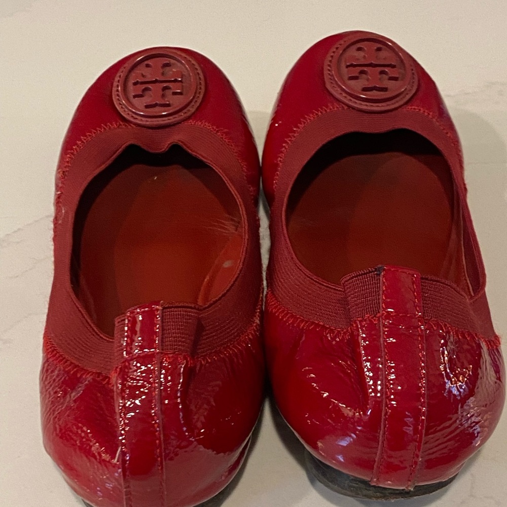 Red Patent Tory Burch ballet slippers. They have been worn.